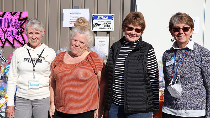 Outdoor photo of four women in fron of Fishline warehouse